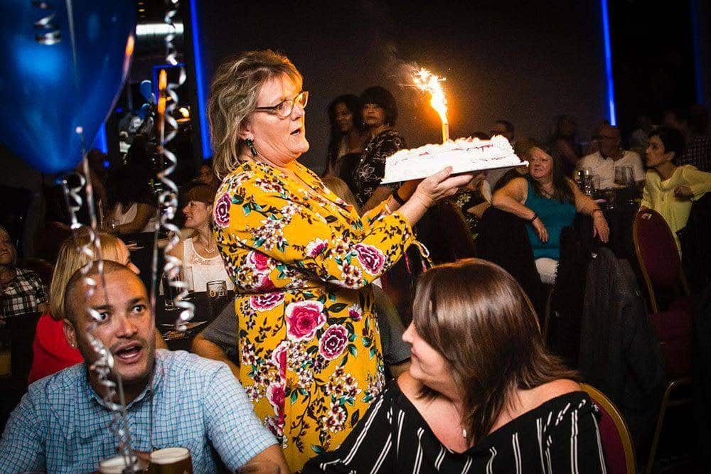 Birthday cake with a sparkler at a party