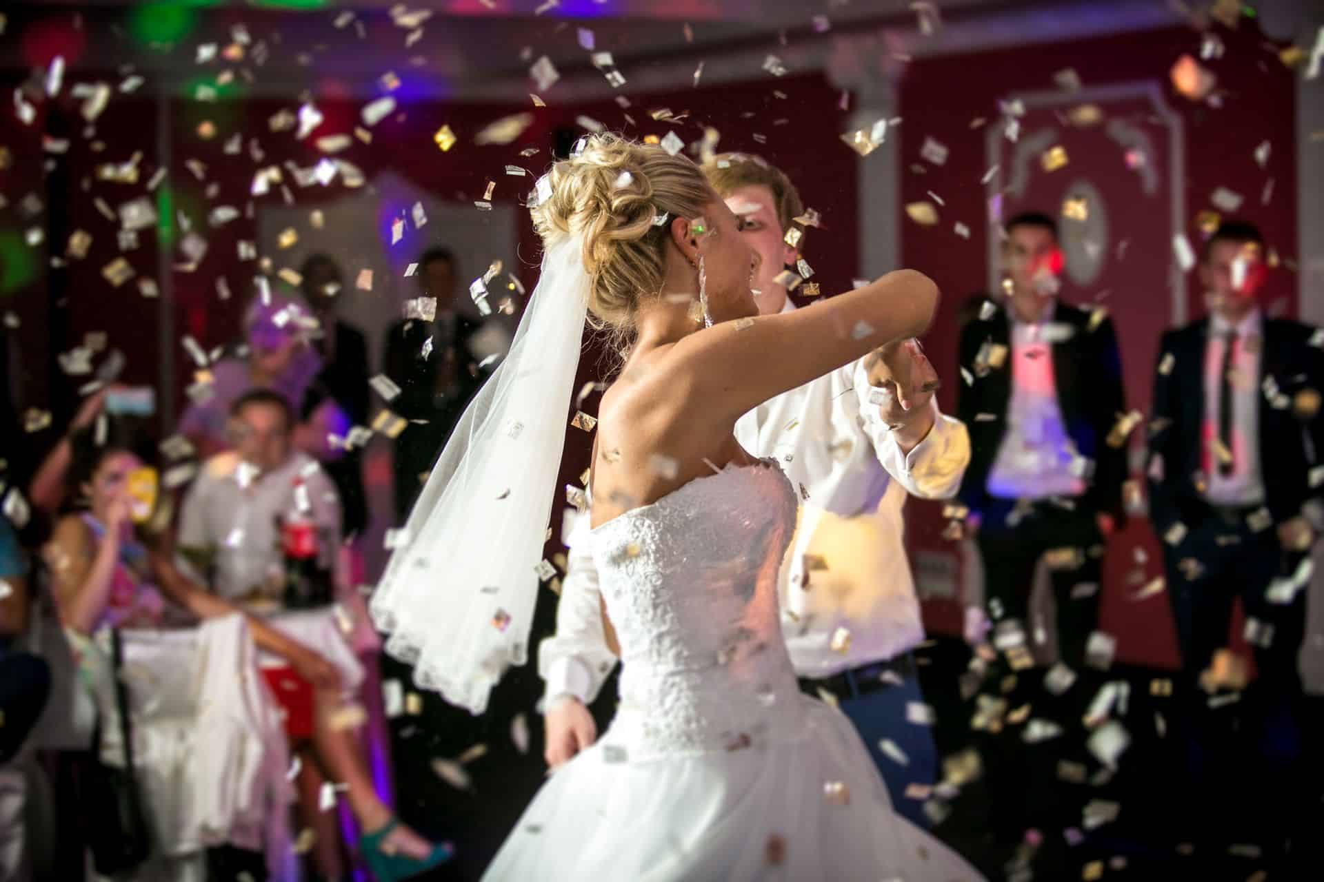 Bride and groom dancing in confetti