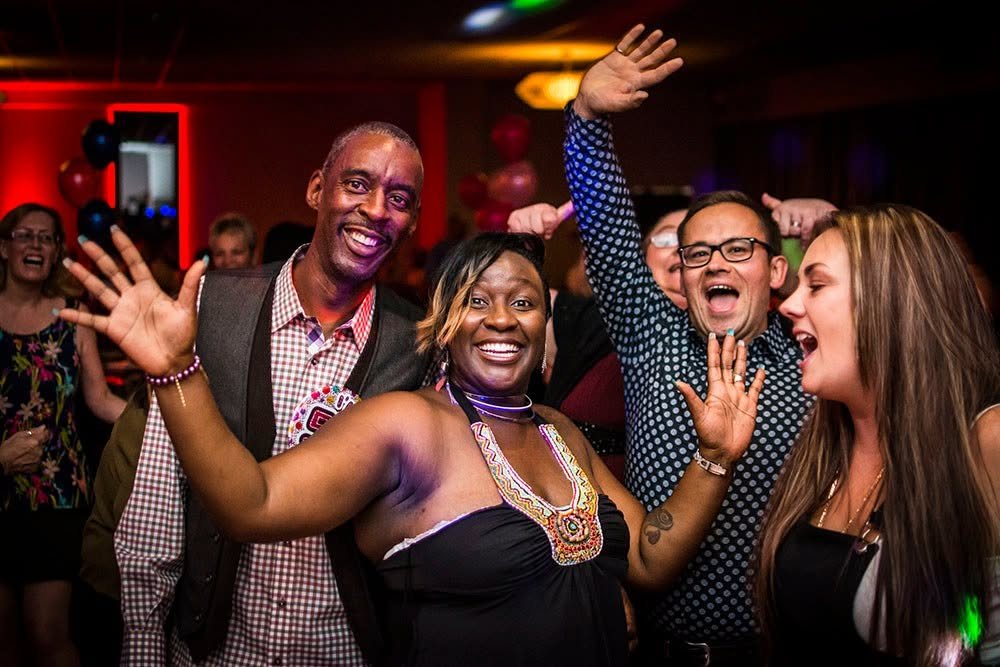 Guests with hands in the air on a Total Eclipse Disco dance floor