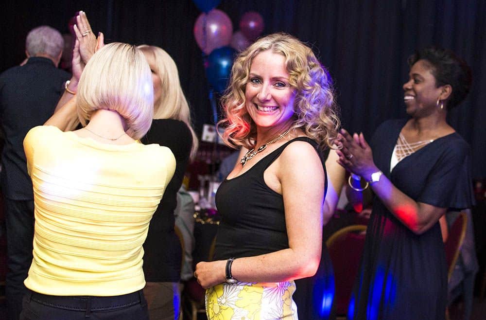 Guests laughing and dancing at a party