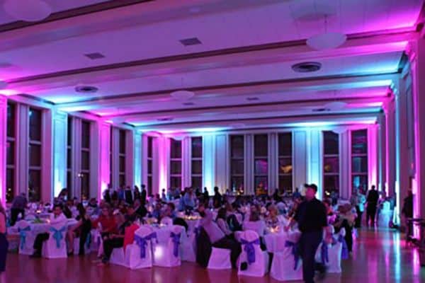 Dining hall lit in pink and blue uplighting