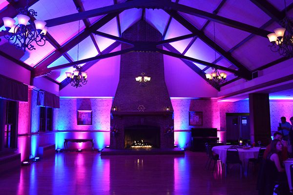 Barn venue lit in purple and blue uplighting