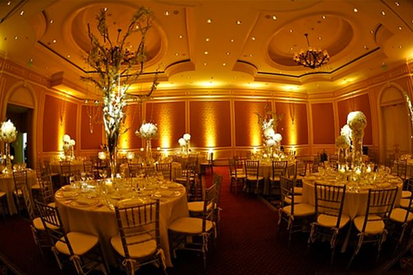 Ballroom glowing in warm gold uplighting