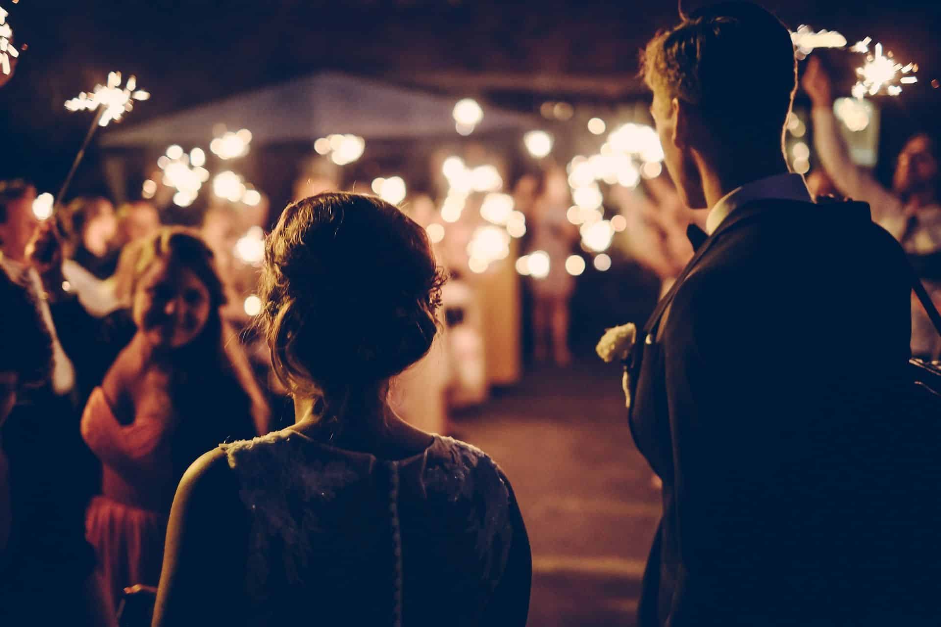 Newlyweds under a tunnel of sparklers